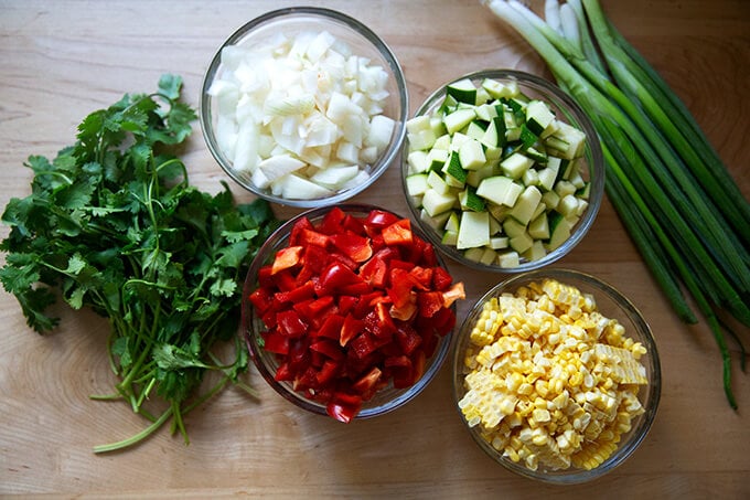 The ingredients to make sautéed summer vegetable tortilla casserole.
