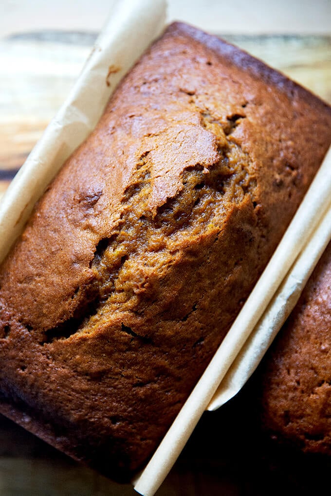 Just-baked pumpkin bread on a board.
