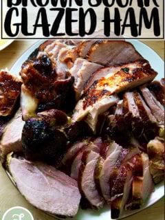 A carved brown sugar glazed ham on a platter.