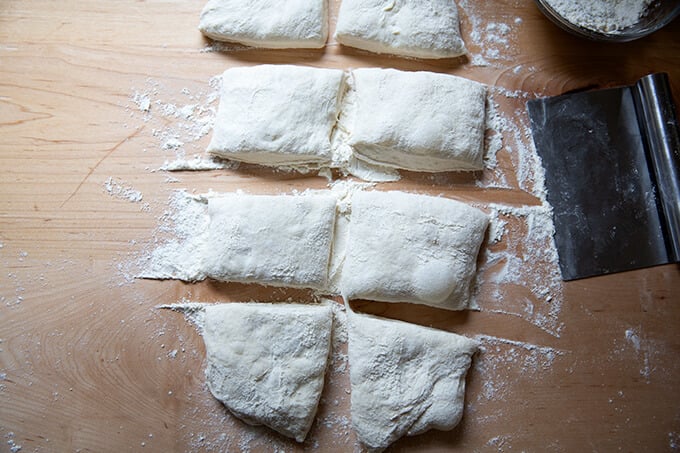 Portioned sourdough ciabatta rolls on a countertop.