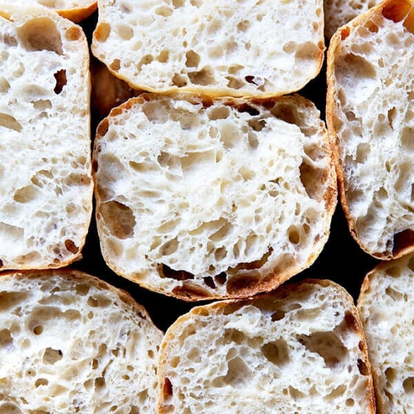 Halved sourdough ciabatta rolls on a countertop.