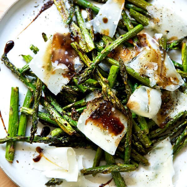 Roasted asparagus with balsamic and parmesan on a plate.