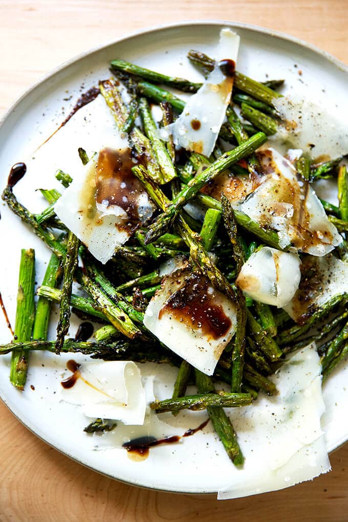 Roasted asparagus with balsamic and parmesan on a plate.