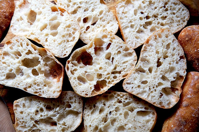 A pile of halved ciabatta rolls.