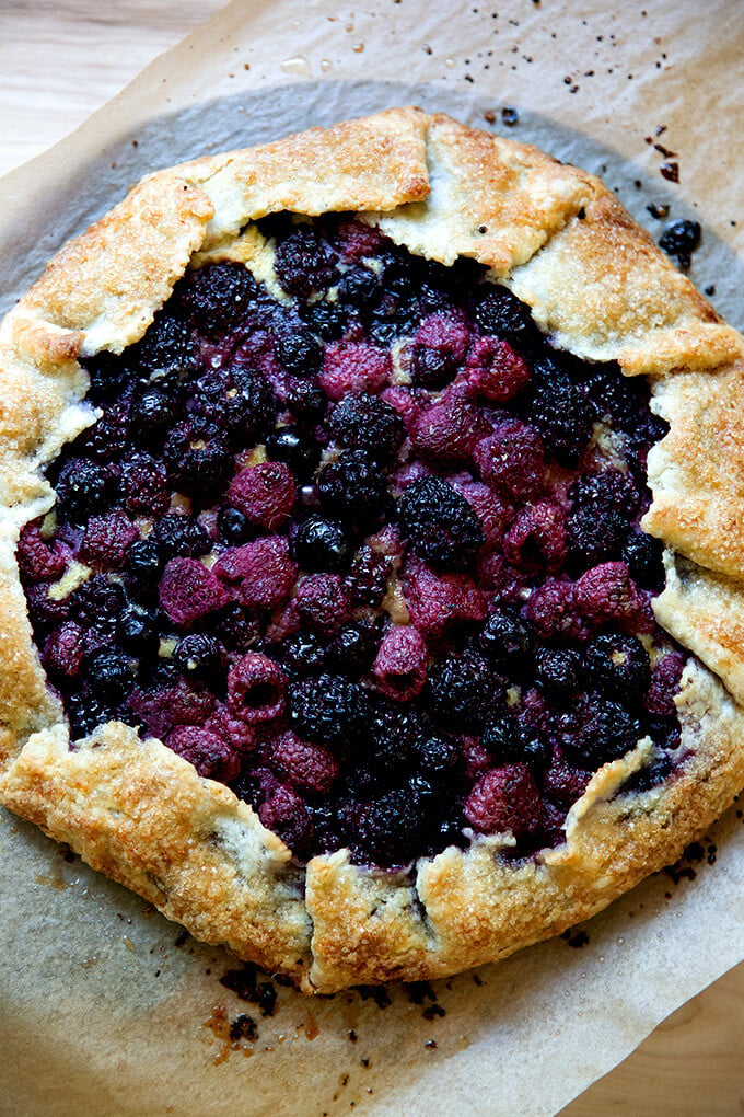 Just-baked mixed berry galette on a board.