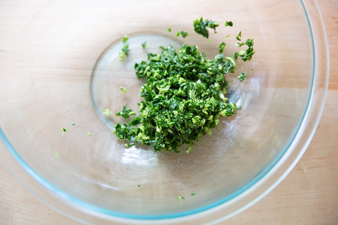 Minced garlic and basil in a bowl.