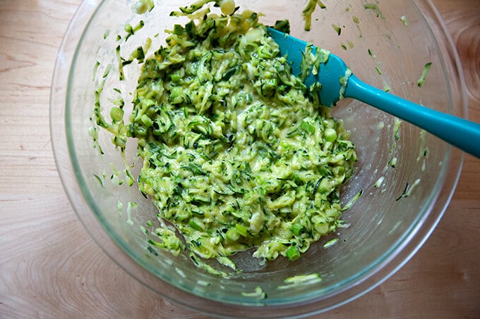 Zucchini fritter batter in a bowl.