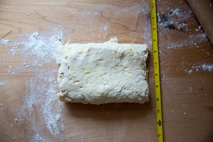 Folded biscuit dough on the counter top.