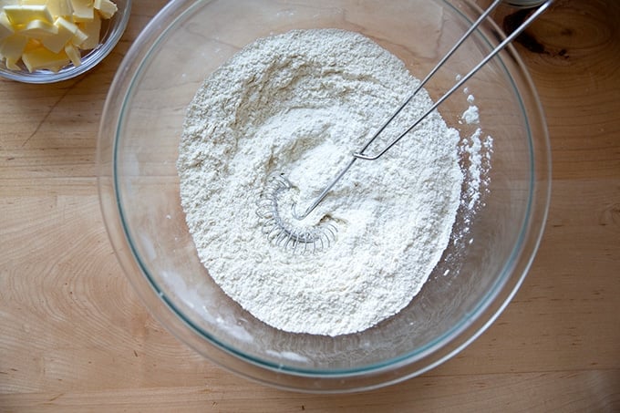 A bowl of flour, salt, sugar, and baking powder mixed together.