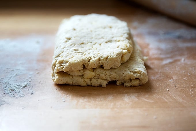 Folded biscuit dough on the counter top.