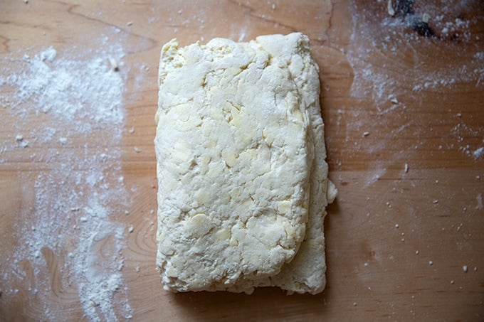 Folded biscuit dough on the counter top.