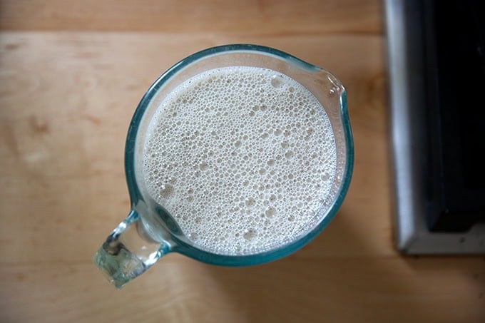 A 2-cup liquid measure filled with buckwheat crepe batter.