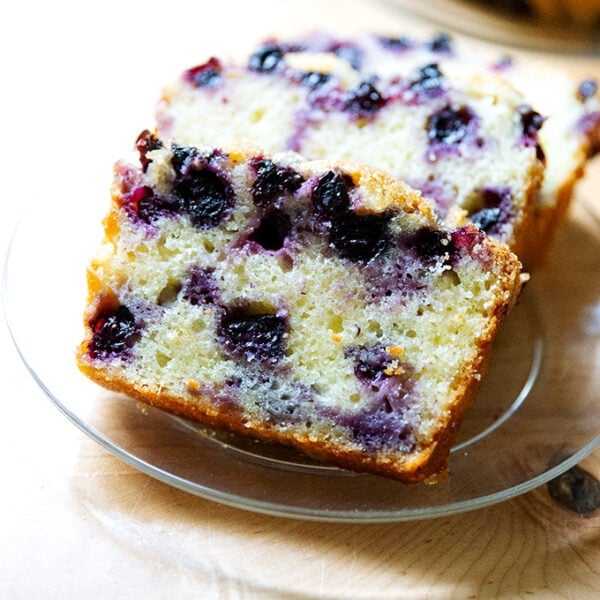 Slices of lemon-blueberry quick bread on a plate.
