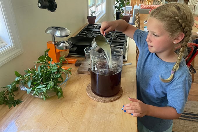 Tig adding lemon juice to the tea.