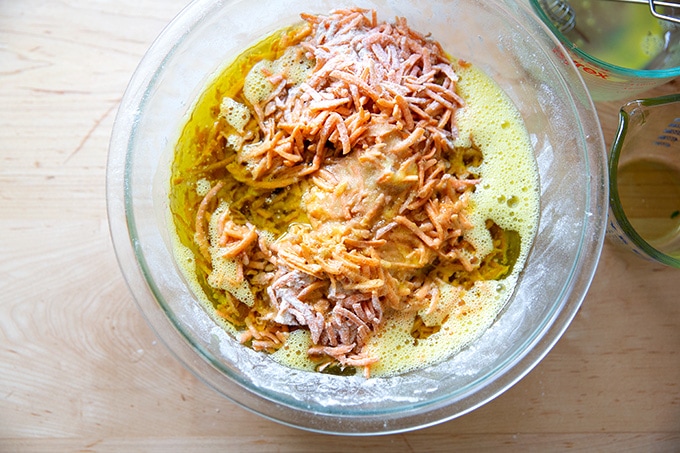 A bowl of unmixed carrot cake batter.