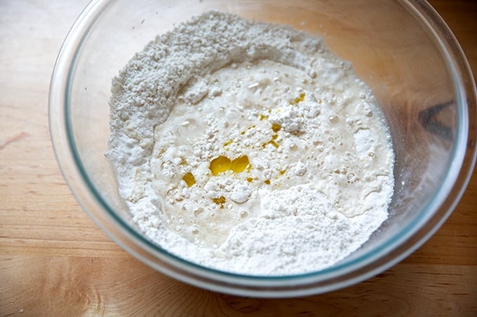 The wet ingredients added to the dry ingredients to make gluten-free pizza dough.