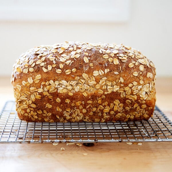Just-baked oatmeal maple loaf on a cooling rack.