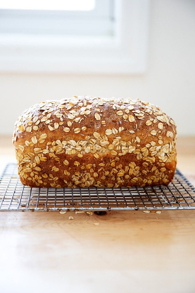 Just-baked oatmeal maple loaf on a cooling rack.