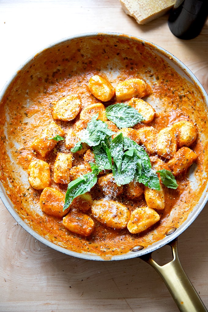 A skillet holding tomato sauced-ricotta gnocchi.