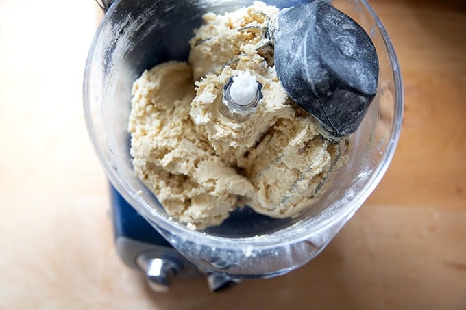 An Ankarsrum mixer filled with chocolate chip cookie dough, chocolate chips yet to be added