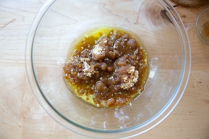 A bowl holding melted butter, brown sugar, and vanilla.