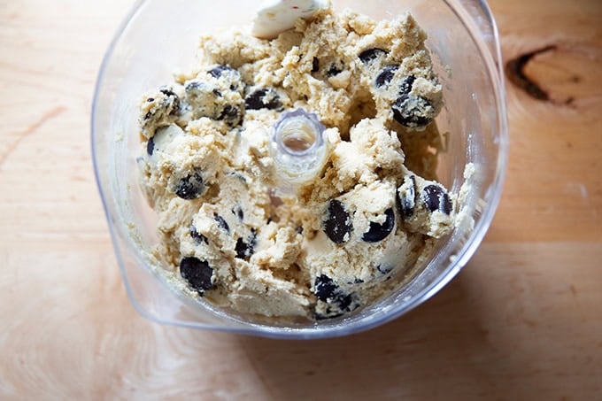 An Ankarsrum mixer filled with chocolate chip cookie dough, finished mixing.