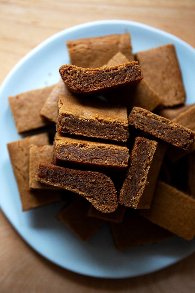 Cut gingerbread cookie bars on a plate.