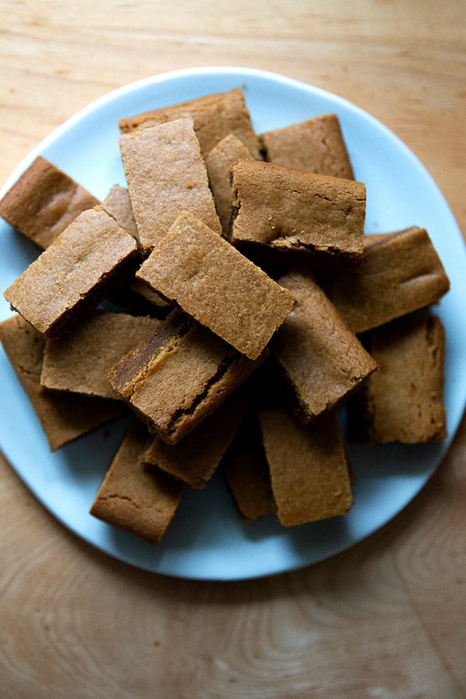 Cut gingerbread cookie bars on a plate.