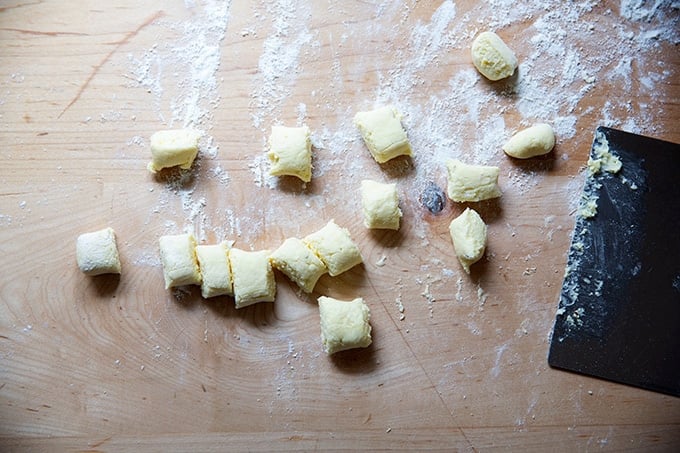 Cut ricotta gnocchi on a work surface.