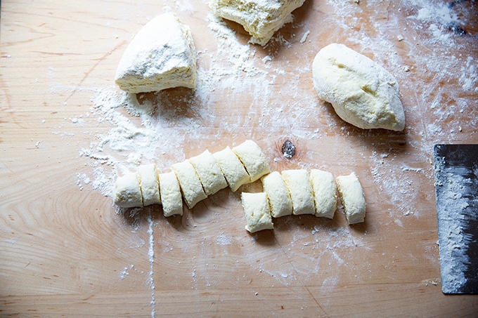 Cut ricotta gnocchi on a work surface.