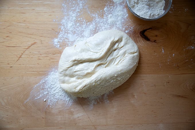 Sandwich bread dough turned out onto a floured work surface.