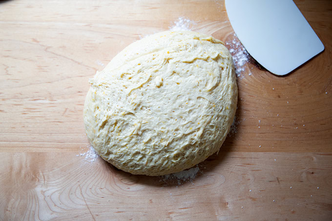 Hot cross bun dough turned out onto a counter top after its first rise.