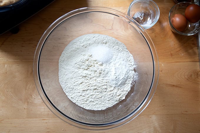 A large bowl filled with the dry ingredients to make soft and chewy chocolate chip cookies.