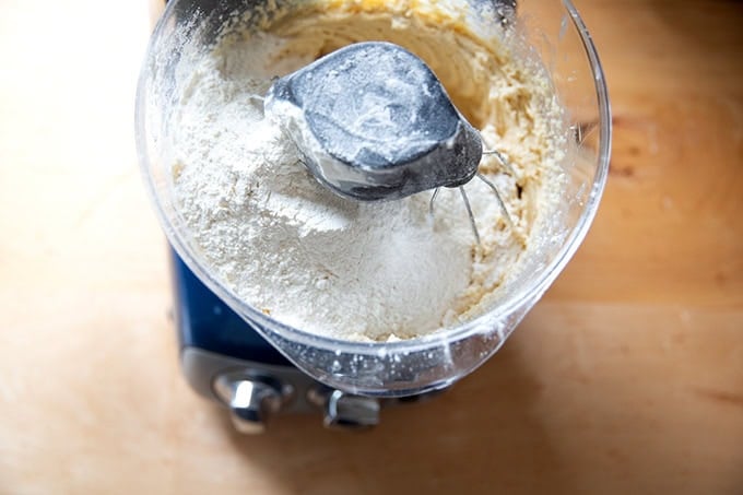 An Ankarsrum mixer filled with creamed butter and sugar, eggs, vanilla, and the dry ingredients to make soft and chewy chocolate chip cookies.