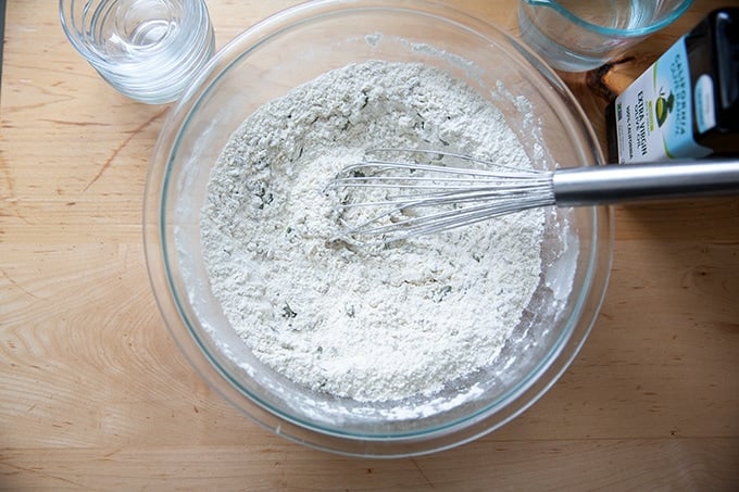 The dry ingredients to make three seed bread whisked together.