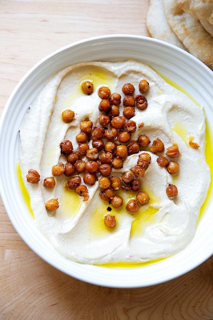 A platter of homemade hummus topped with crispy chickpeas.