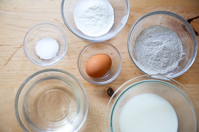 The ingredients to make buckwheat crepes measured out on a countertop.