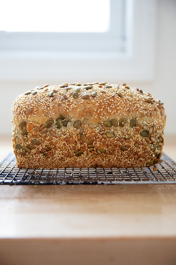 Just-baked three seed bread on a cooling rack.