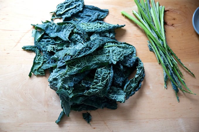 Stemmed Tuscan kale on a counter top.