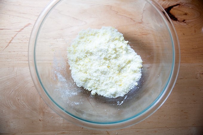 A bowl of lemon and sugar mixed together.