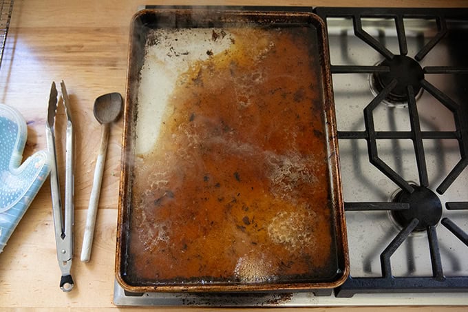 A sheet pan spread across two burners filled with 2 cups of water.