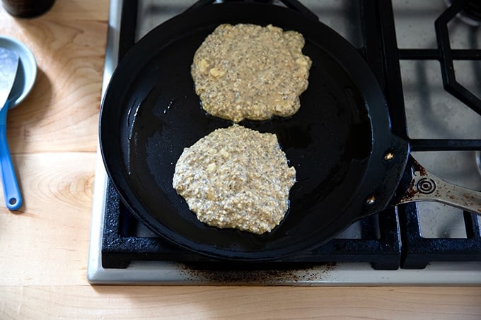 Banana-oat pancakes in a skillet.
