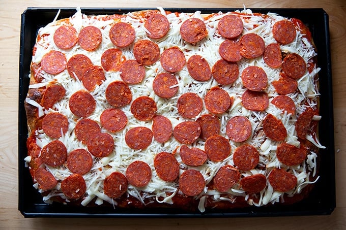 A pan of Sicilian-style pizza ready for the oven.