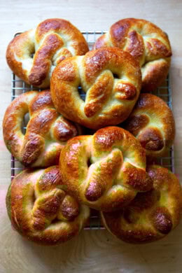 Just-baked soft pretzels on a cooling rack.