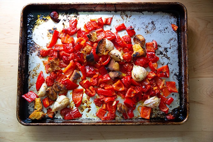 Roasted vegetables for romesco sauce on a sheet pan.