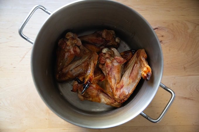 Roasted turkey wings in a large pot.