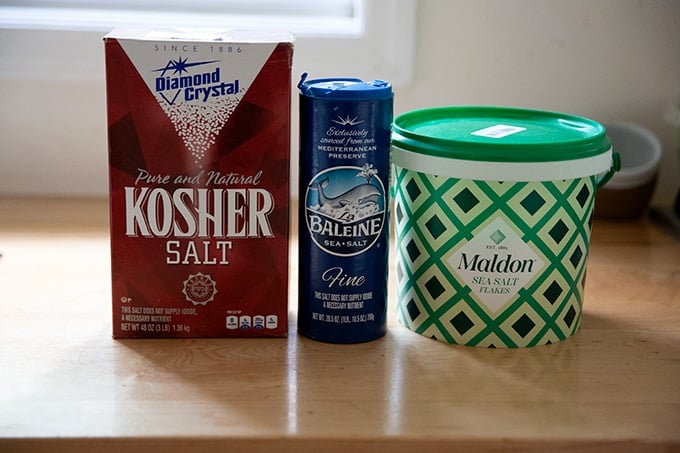 Three vessels of salt: kosher, fine sea, flaky sea.