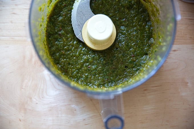 A blended mix of seasonings and flavorings for turkey burgers in a food processor.