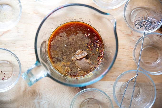 Un-whisked miso-lime sauce in a 4-cup measure.