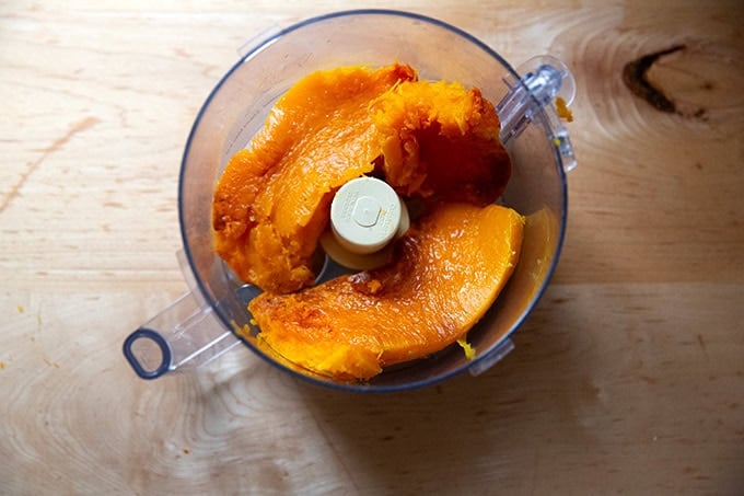 A food processor filled with roasted butternut squash.